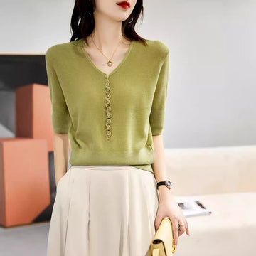 Camiseta de punto de manga tres cuartos holgada y moderna para mujer